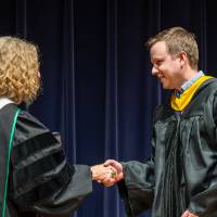 faculty on stage receiving award